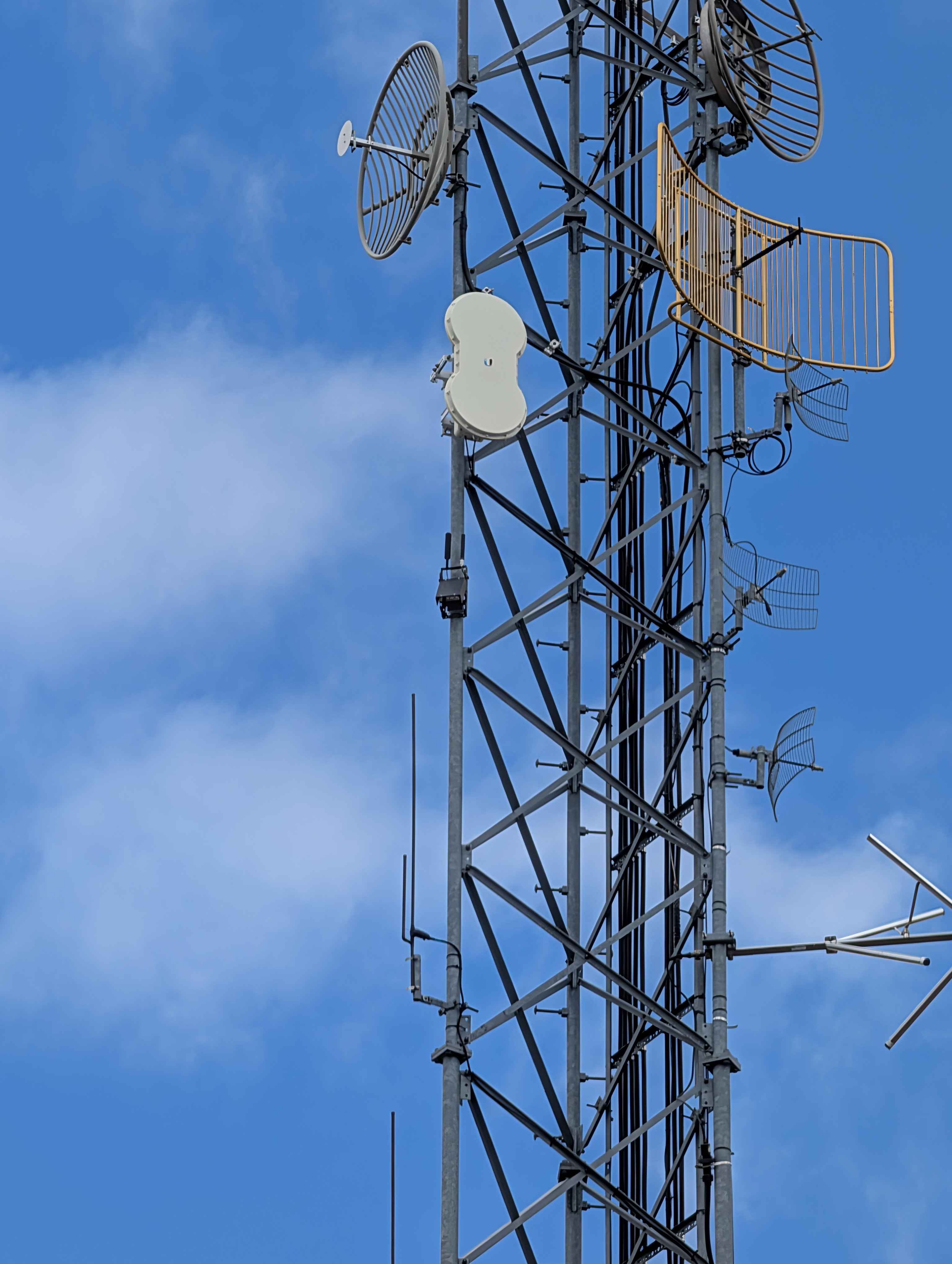Looking up at the tower from the ground, showing the array of antennas the Beacon shares the structure with