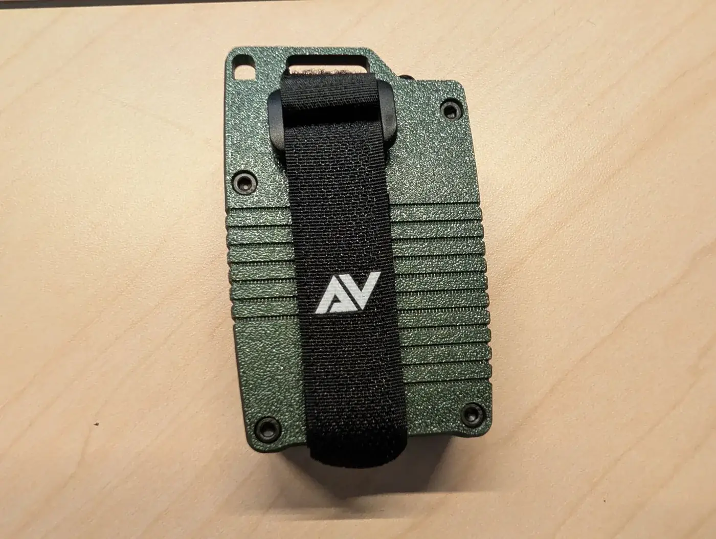 The Atlavox M1 with its Atlavox hook-and-loop strap threaded through the top slot